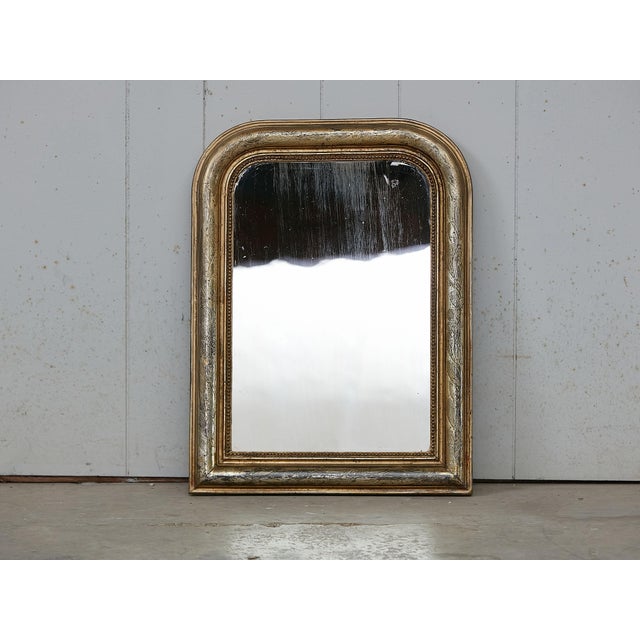 A French Louis-Philippe style gilt mirror from the early 20th century, with etched foliage motifs. Created in France...