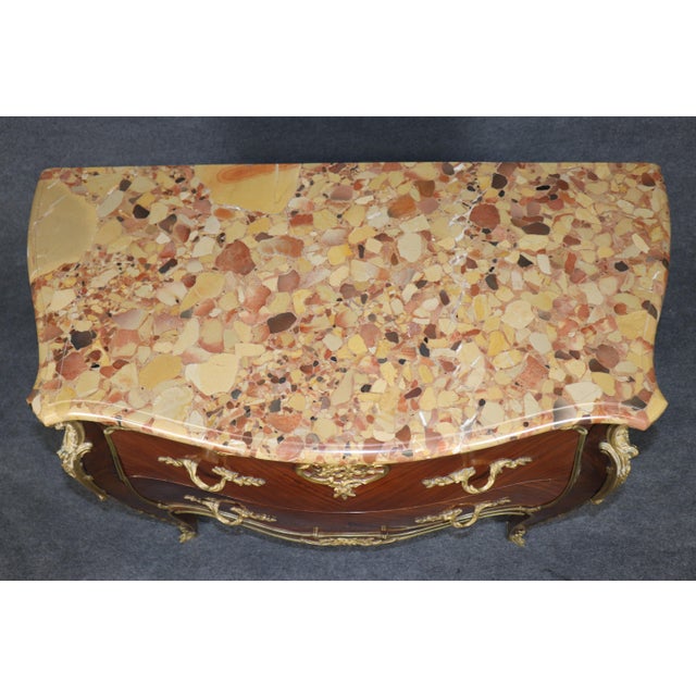 French Louis XV-Style Marble-Top Kingwood Commode with Gilt-Bronze Mounts A particularly elegant and richly appointed...