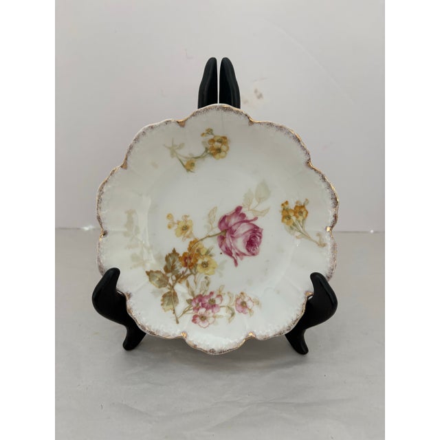 Beautiful antique Bavarian porcelain butter pats featuring hand-painted pink roses with soft yellow blossoms on a creamy...