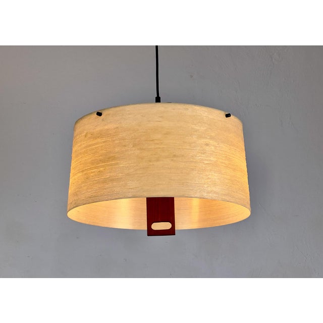 Decorative pendant light with teak wood elements and a textured fiberglass shade. Two E27 sockets. • Manufacturer: Erco •...