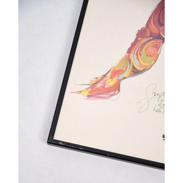 Lithographic print signed by bjørn wiinblad. Framed in a black frame with the artist's characteristic motif. — artist:...