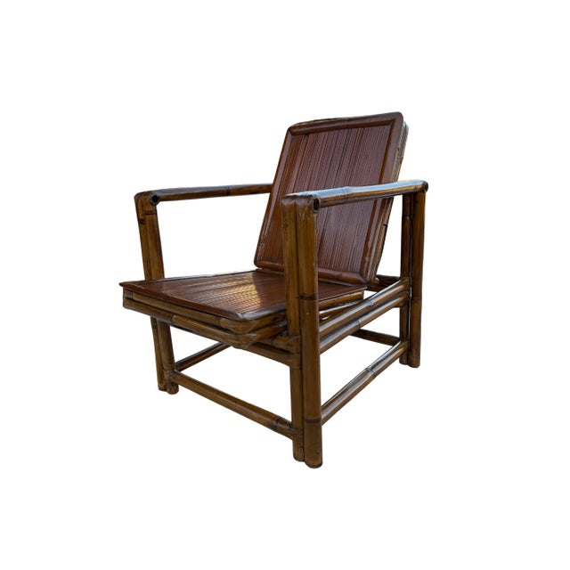 A Pair of Vintage Bamboo Lounge Chairs These beautiful lounge chairs feature a robust, dark-stained bamboo frame,...
