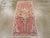 This mid-20th century Turkish Oushak rug, displays a graceful and highly stylized floral arrangement set against a warm,...