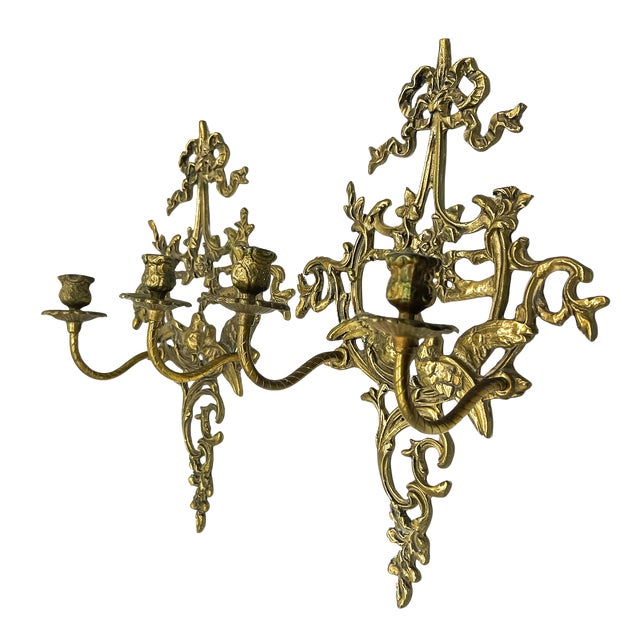 Charming, large-scale pair of vintage cast brass two-candle wall sconces featuring a pair of sweet lovebirds perched among...