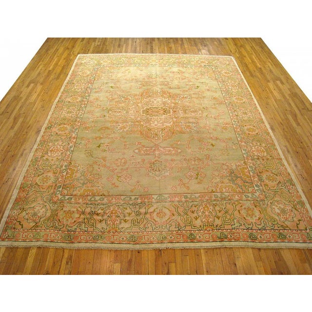 An antique Turkish Oushak oriental carpet, size 13'2 x 10'3, circa 1910. This lovely decorative carpet features a diffuse...