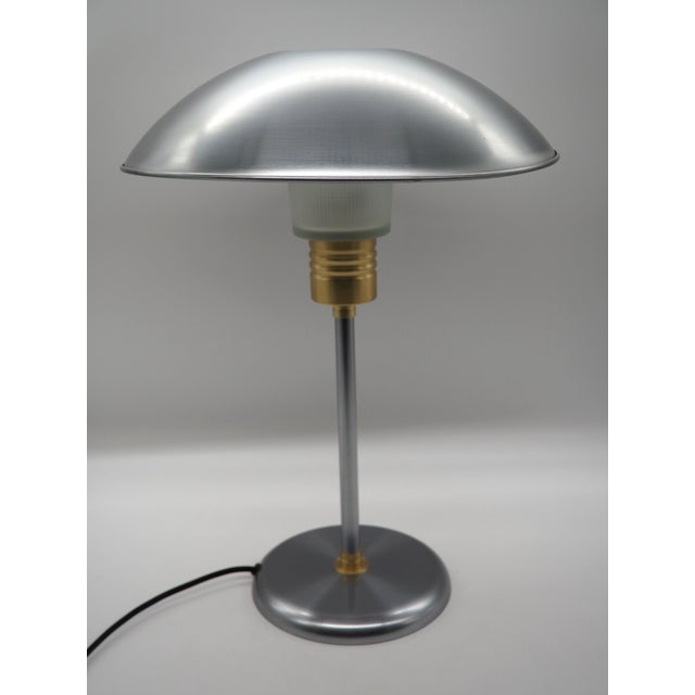 Scandinavian modern table lamp "ufo" in brushed metal and frosted glass. this model (type b0208) combines a dome-shaped...
