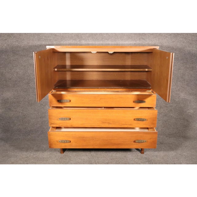 Tall chest of drawers designed by Pierre Debs for Bassett furniture. Rich walnut with brass hardware. Three wide drawers...