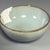 Classic Chinese celadon bowl with elegant rounded shape, finished in soft pale‑blue‑green glaze covered with fine natural...