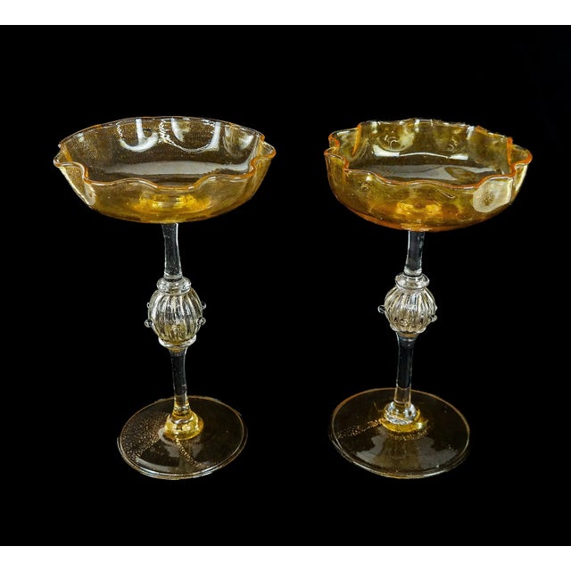 Pair of Venetian art glass colorless and gold flecked "Aventurine" ,the wavy shallow bowls above long narrow rods each...