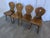 Set of 4 vintage wooden dining chairs in Tyrolean style. The chairs feature solid wooden construction with bobbin-turned...