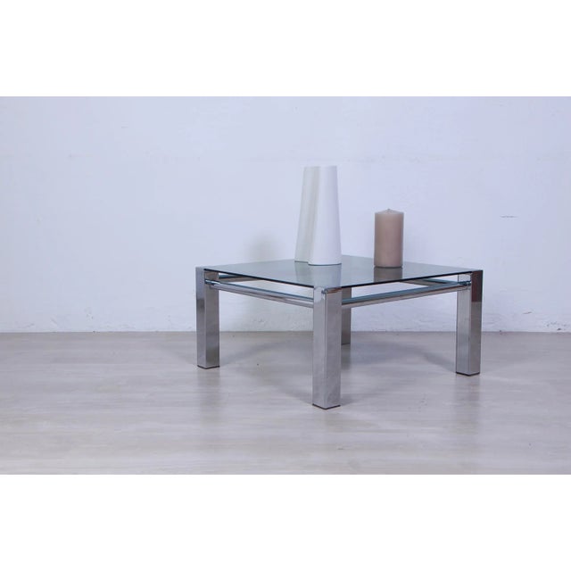 Beautiful 70s design and production table. Steel structure, fumè glass top. The lack of a black foot is reported.