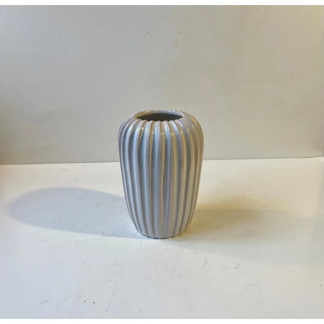 Art deco revival ceramic vase from the 1960s. Fluted fully glazed corpus in white glaze. Its designed by Eslau in Denmark...