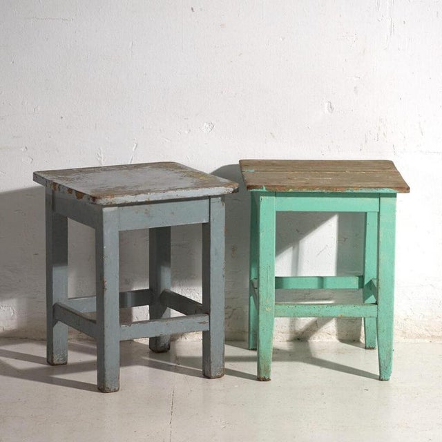 A pair of antique bedside tables in pine wood, with a square top and four tapered legs tied by box stretchers. They...
