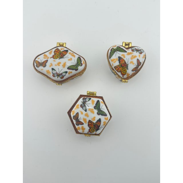 Three ceramic butterfly trinket boxes. These items are pre owned so please see all pictures and ask any questions.