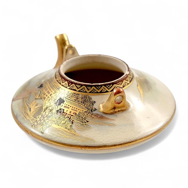 A refined example of Kyoto Satsuma art pottery, this tripod koro incense burner was created by the respected Kotobuki-dō...