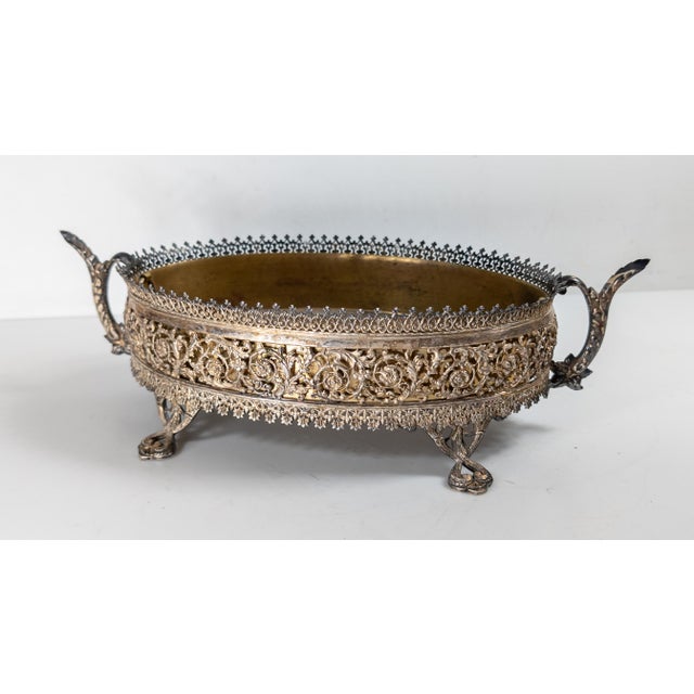 We are selling this really pretty Silverplate and brass jardiniere. This planter has really great reticulated openwork...