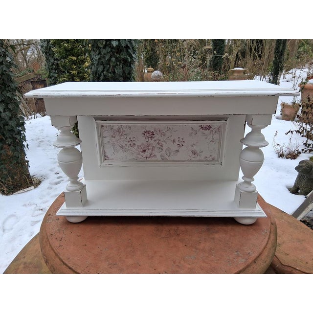 Antique, romantic, with a rose design and plenty of shabby chic patina – this wall console embodies it all. The feet are...