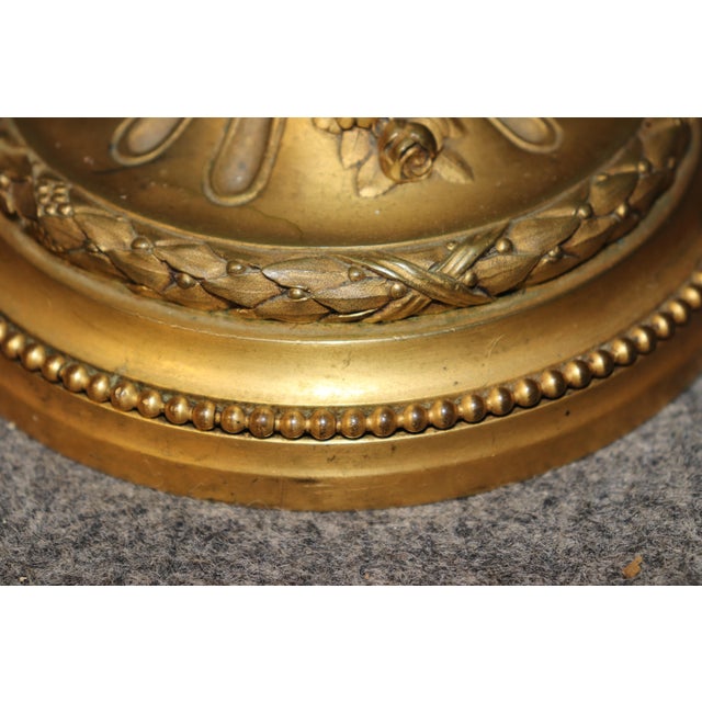 This exquisite French bronze-mounted ormolu table lamp is a masterful expression of Neoclassical elegance, combining...