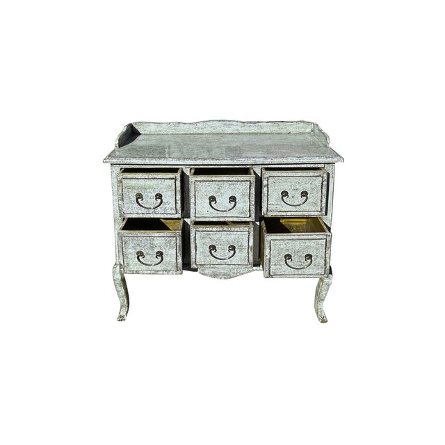 This charming antique-style dresser exudes rustic elegance with its weathered, pale blue green finish that hints at years...