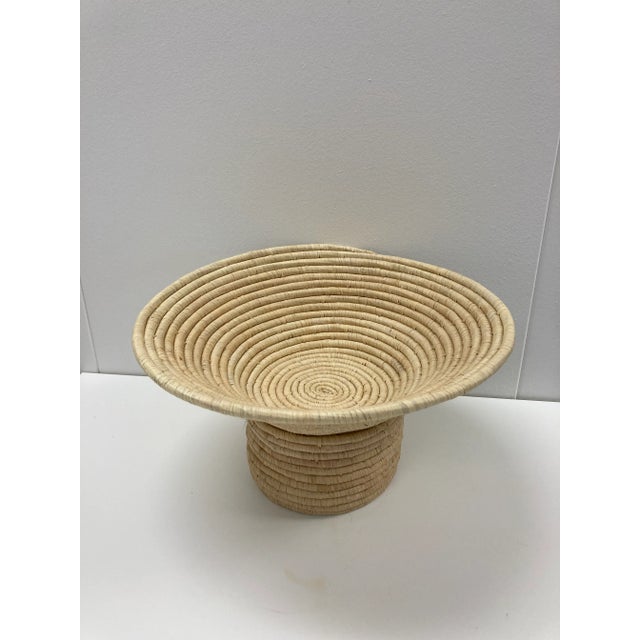 This large all-natural fiber bowl was handmade by women in rural Rwanda, in a fair trade environment. Its natural sisal...