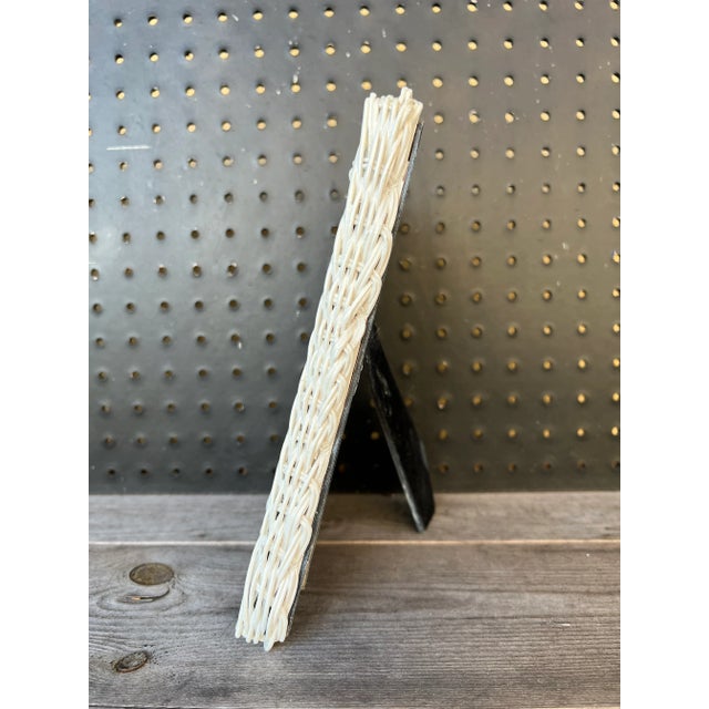 Vintage white wicker picture frame. Inside measure 4 1/4” x 6 1/2”. The velvet backing is original with closures....