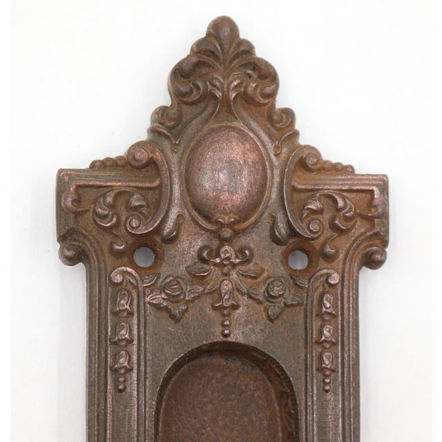 Victorian style pocket door recessed pull made of cast iron with a black finish. Made by Reading. Pattern Reole. The...