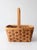 This vintage woven basket features a rectangular splint frame interwoven with twisted natural fiber and a tall bentwood...