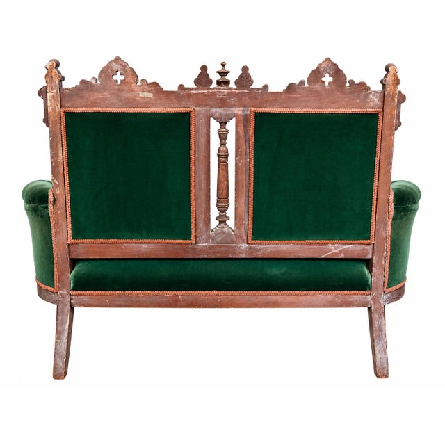 This 19th century Victorian Eastlake settee is a striking example of the era's fusion of Eastlake and Gothic Revival...