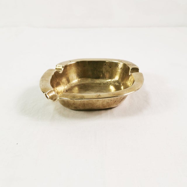 Ashtray, Germany, 1960s. It features an asymmetrical, minimalist design. Made of thick brass. Condition: good to very...