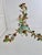 Rare 1950s Italian Florentine three-light chandelier crafted from painted and gilt tole iron with an elaborate arrangement...