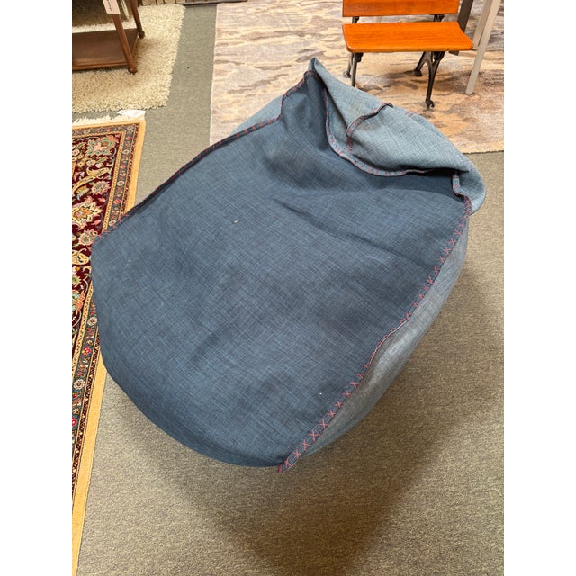 Design Plus Gallery presents a Bean Bag Lounge Chair with Nautical Style. The bean bag has a red whipstitch that joins...