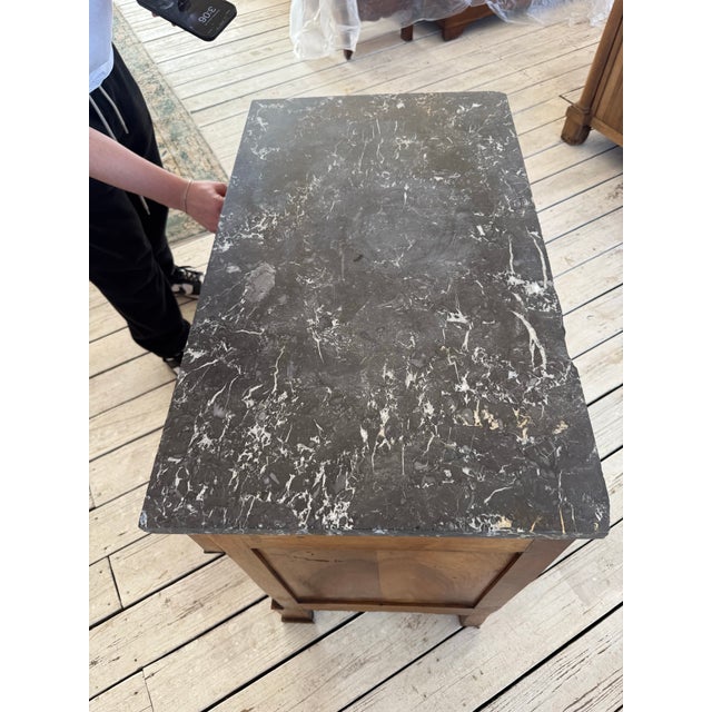 19th Century French Empire Commode from Paris France. Made of walnut, with a marble top, the wood has been finished with...