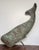 A sperm whale in copper, cut and shaped from sheet stock with a silhouette that reads instantly from across a room. The...