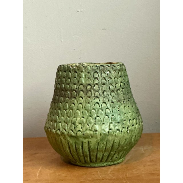 This vintage green ceramic vase captures the organic sensibility of mid-20th century design, its slightly bulbous...