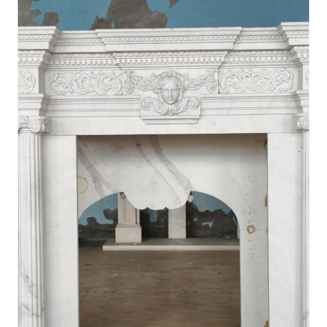Commanding in presence and rich in classical detail, this monumental white marble fireplace mantle exudes refined...