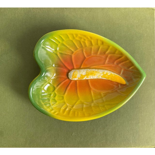 A classic botanical ceramic accent dish depicting a beautiful textured anthurium flower native to Hawaii in the vivid...
