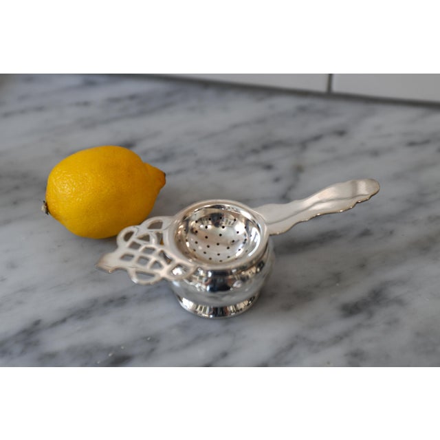 This is a very nice vintage tea leaf strainer with a reticulated handle and hammered nesting bowl. Only light signs of...