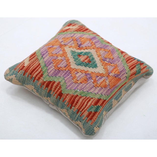 A one-of-a-kind handwoven Afghan wool kilim accent pillow featuring layered diamond medallion. Cut and sewn by hand from a...