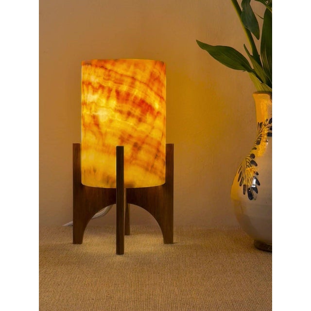 Comet pairs a hand-carved Egyptian alabaster shade with a geometric walnut base, combining contemporary form with...