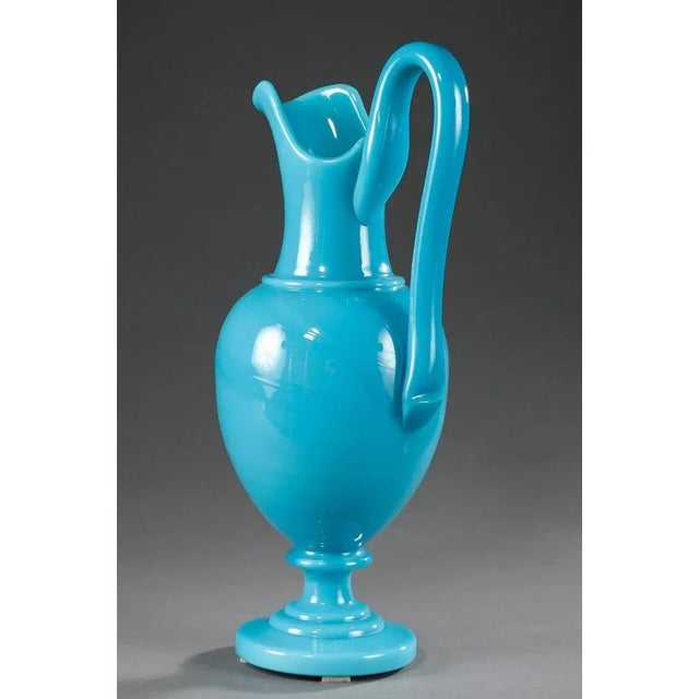 Charles x light-blue opaline ewer with a high handle and resting on a circular foot. Its delicate color and the purity of...