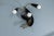 Italian Mid-Century Modern wall lamp in the style of Stilnovo, circa 1960. Sculptural three-light wall lamp combining...