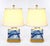 This elegant pair of late 20th-century table lamps features glazed porcelain bodies decorated in a traditional blue and...