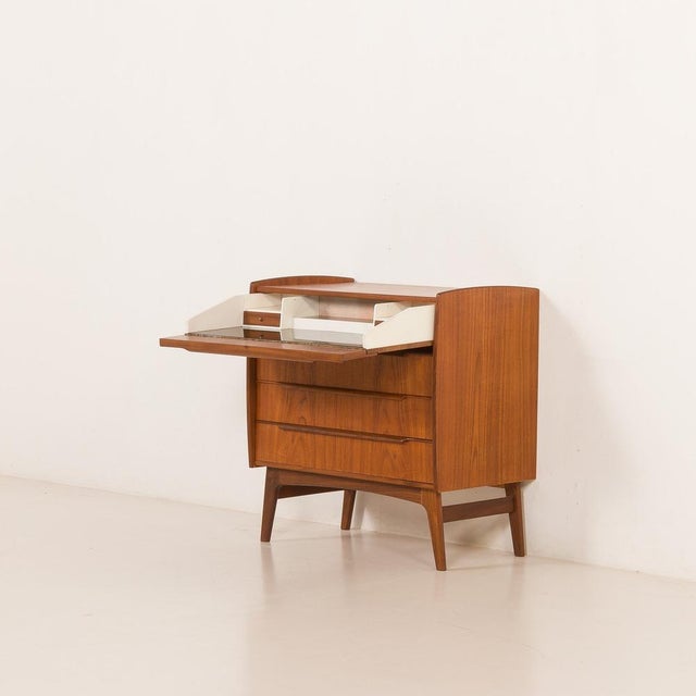 This elegant Danish chest of drawers with hidden desk can serve also as vanity . It comes from the 1960s and combines...