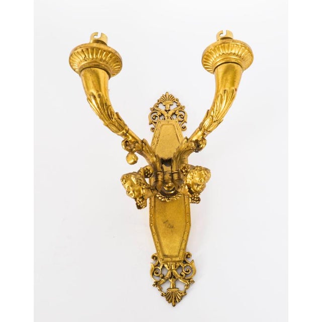 This is an elegant pair of antique French Louis XIV Revival ormolu gilt wall-light sconces, Circa 1840 in date. Each wall...