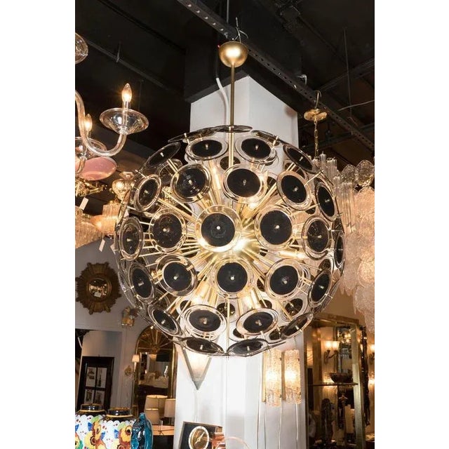 This outstanding Modernist Sputnik chandelier by Vistosi features a satin finished brass frame with a spherical core from...