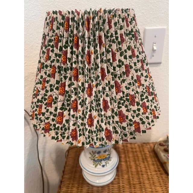 This is a vintage-style porcelain lamp adorned with painted floral motif, creating a cottage-core aesthetic suitable for...