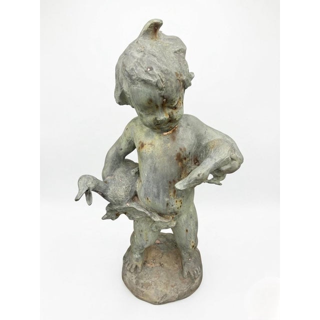 This exceptional Italian bronze garden fountain features a classic Neoclassical "Boy with Geese" motif, standing 23 inches...