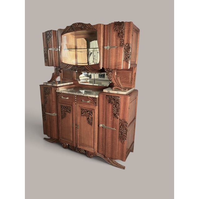 A representative Art Nouveau oak buffet, likely made around 1900–1915. This exceptionally large piece of furniture...