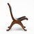 A striking pair of mid-century lounge chairs combining sculptural wooden frames with beautifully formed black leather...