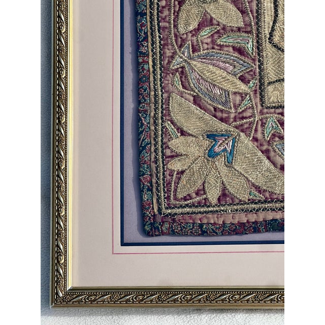 This framed textile is an antique Middle Eastern bullion goldwork embroidery, likely originating from the Ottoman Empire...